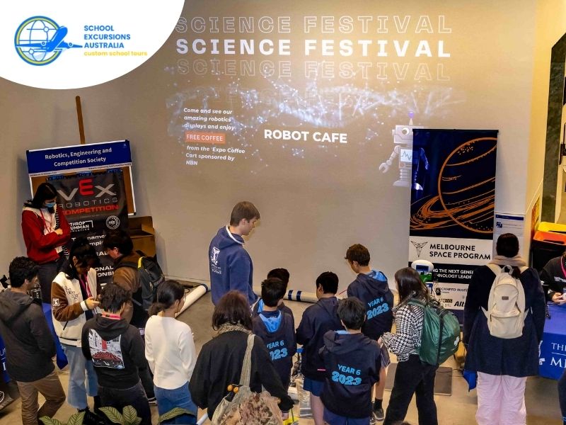 Students attending a science festival in Melbourne exploring robotics and engineering exhibits during a STEM school excursion